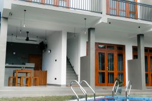 a house with a pool in front of it at Fathers Place Hiriketiya in Dickwella