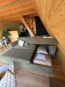 a living room with a couch in the attic at L Atypique in Saint-Éloi