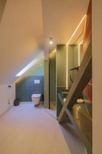 a bathroom with a sink and a toilet at Céhes Guesthouse in Tîrgu Secuiesc