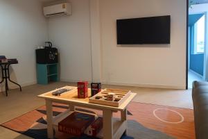 a living room with a table with dominoes on it at Mt Olympus Retreat Hotel in Mae Nam
