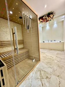 a shower in a bathroom with a glass wall at Les Eclats d'Amour in Chargé +31 photos
