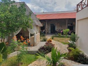 a building with a group of people sitting inside of it at Merida Santiago Hotel Boutique in Mérida