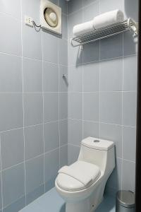a bathroom with a white toilet and blue tiles at المواسم in Tabuk