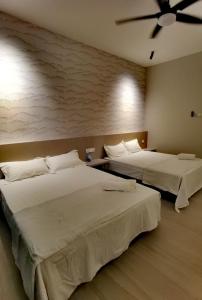 two beds sitting next to each other in a room at Seaview Cozy BS Homestay in Kota Kinabalu