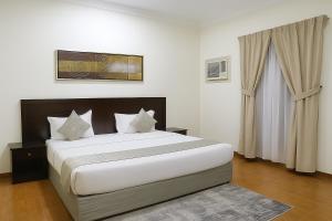 a bedroom with a large bed in a room at المواسم in Tabuk