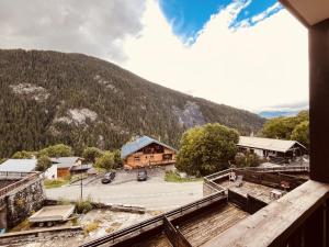 a view from a balcony of a building with a parking lot at Charmant 2 pièces pour 5 pers. au cœur de Peisey Village - FR-1-757-125 in Landry +4 photos
