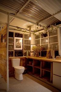 a bathroom with a toilet and a wooden counter at Embibi Campground, Cabin and Retreat in Ngong