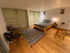 a bedroom with a bed and a wooden floor at Embibi Campground, Cabin and Retreat in Ngong