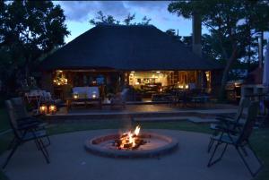 a fire pit in the middle of a patio at Kudusdrift Farmstay in Vaalwater +14 photos