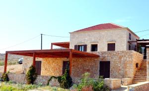 a stone house with a staircase in front of it at Villa Blu Majestic beach villa in Halki