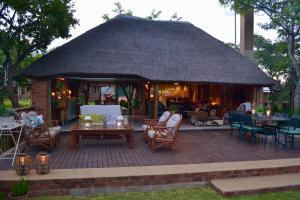 a gazebo with chairs and tables on a patio at Kudusdrift Farmstay in Vaalwater