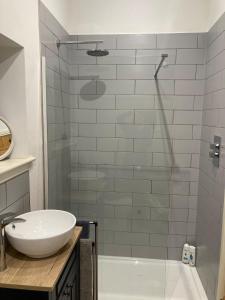 a bathroom with a sink and a glass shower at Peace & Tranquillity - Breathe Nature & Star Gaze in Eaton