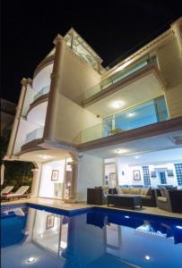 a house with a swimming pool in front of it at Villa Mercan in Kalkan