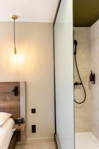 a bathroom with a shower and a bed and a shower at Le Trèfle in Portet-sur-Garonne