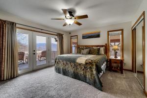 a bedroom with a bed and a ceiling fan at Dream Weaver in De Hart Mill +37 photos