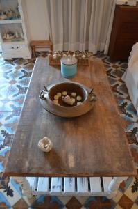 a wooden table with a bowl on top of a table at Villa Blu Majestic beach villa in Halki