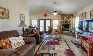 a living room with a couch and a flat screen tv at The Cottage on Douglas Lake Cove in Dandridge