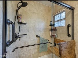 a bathroom with a shower with a glass door at The Cottage on Douglas Lake Cove in Dandridge +20 photos