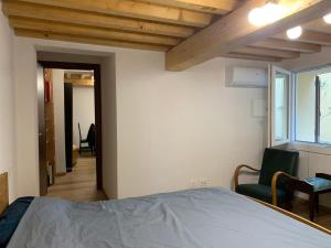 a bedroom with a bed and a chair and a window at Centrocitta' in Carpi