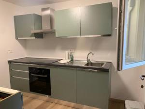 a kitchen with a sink and a counter top at Centrocitta' in Carpi