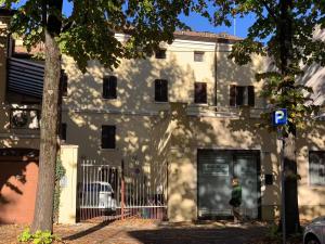 a person standing in front of a building at Centrocitta' in Carpi +22 photos
