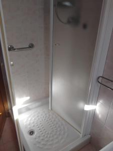 una ducha con puerta de cristal en un baño en Casa vacanze La Vigna, en Chiusi