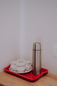 a tray with cups and saucers on a table at Camplights Stays in Tariyod