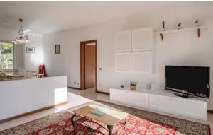 a living room with white cabinets and a flat screen tv at Villa BramaRosa in Montecatini Terme