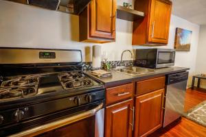 a kitchen with a stove and a sink at 1 Bed Apt - Amazing Location 1 Block to Carson St in Pittsburgh