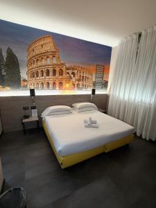 a bed in a room with a painting of the coliseum at Jet Hotel, Sure Hotel Collection by Best Western in Gallarate