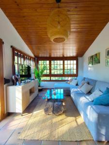 a living room with a blue couch and a wooden ceiling at villa aranda in Llagostera