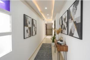 a hallway with black and white art on the walls at Via Premium Room I in New Delhi