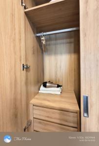 a room with a wooden paneled wall with a wooden table at Chanhchua Apartment Quy Nhon in Quy Nhon