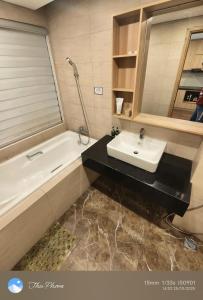 a bathroom with a sink and a bath tub at Chanhchua Apartment Quy Nhon in Quy Nhon