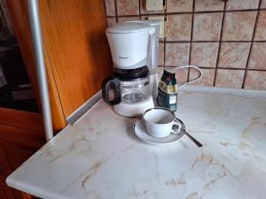 a coffee maker on a counter with a cup of coffee at Dinaki apartment in Florina +30 photos