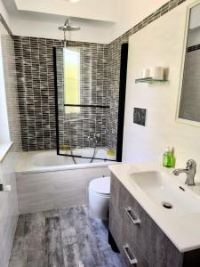 ein Badezimmer mit Badewanne, Toilette und Waschbecken in der Unterkunft Chill out Home Fregene Family Group Accomodation - 15 minuti da Fiumicino - Casa Vacanza Fregene vicino al mare in Fregene + 37 Fotos