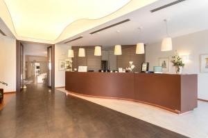 a lobby with a reception desk in a building at Hotel Napoleon in Cherasco +32 photos