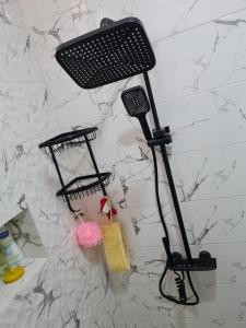a black microphone on a wall next to a wall at Modern luxury apartment -f4- central Sétif in Sétif