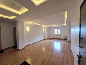 an empty room with white walls and wooden floors at Modern luxury apartment -f4- central Sétif in Sétif