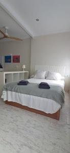 a bedroom with a large bed in a white room at Estudio Vista Mar & Piscina - 200 m de la playa in Aguadulce +7 photos