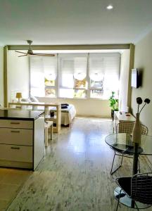 a large living room with a bed and a table at Estudio Vista Mar & Piscina - 200 m de la playa in Aguadulce