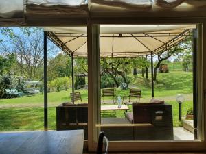 a patio with an umbrella and a table and benches at La Davana Parma in Salsomaggiore Terme