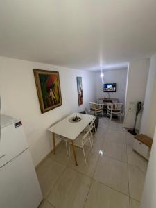 a living room with a table and a refrigerator at יחידת דיור חדשה עם מקלט - היחידה בגליל in Qiryat Shemona