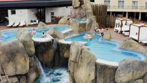 a water slide in a resort with people in it at Elegant City House Moderno no Centro da Cidade in Chaves