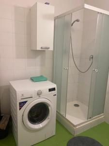 a washing machine in a bathroom with a shower at Flat in Center Teplice in Teplice