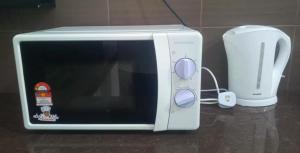 a white toaster oven and a blender on a counter at 家家民宿 in Nibung Tebal +6 photos