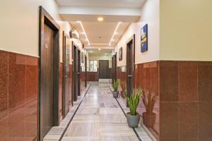 a hallway with potted plants in a building at FabHotel Sonargaon - Near park street in Kolkata