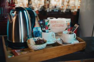 Una bandeja de madera con tazas y un libro sobre la encimera en CASA DA ILHA INN and SPA Anexo2, en Angra dos Reis 13 fotos más