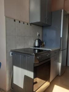 a kitchen with a tea kettle on the counter at Kumanovo Square in Kumanovo +14 photos