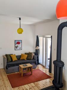 a living room with a couch and a black stove at Hikers' Corner - Planinarka in Kolašin